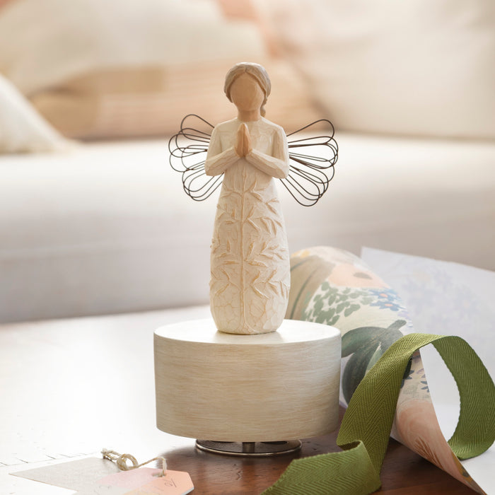 Decorative angel figurine on a table with a blurred background