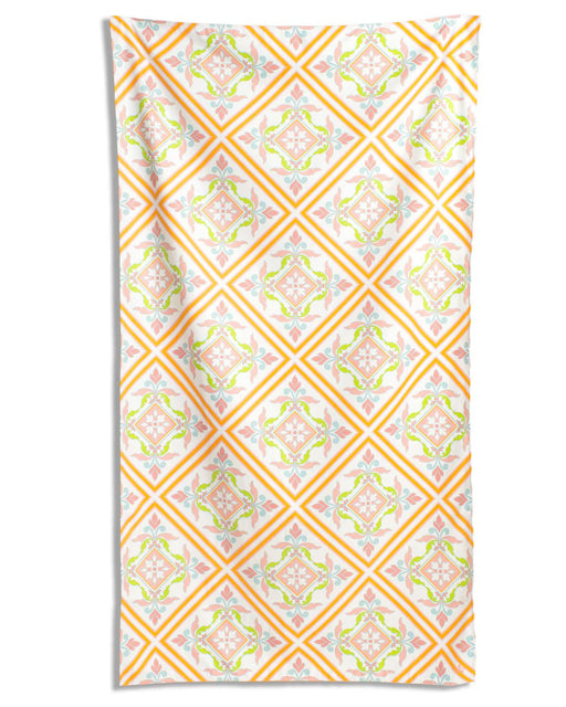 Patterned towel with orange and pink design on a white background
