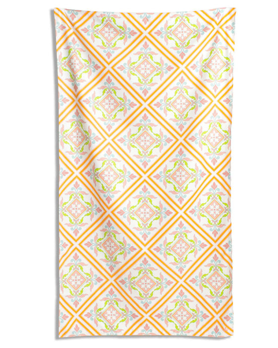 Patterned towel with orange and pink design on a white background