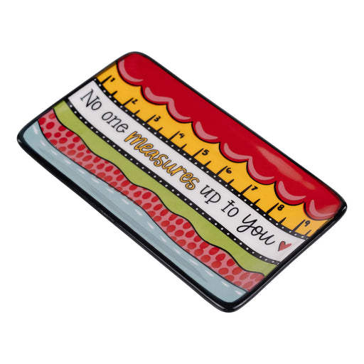 Colorful ruler-shaped object with text on a white background