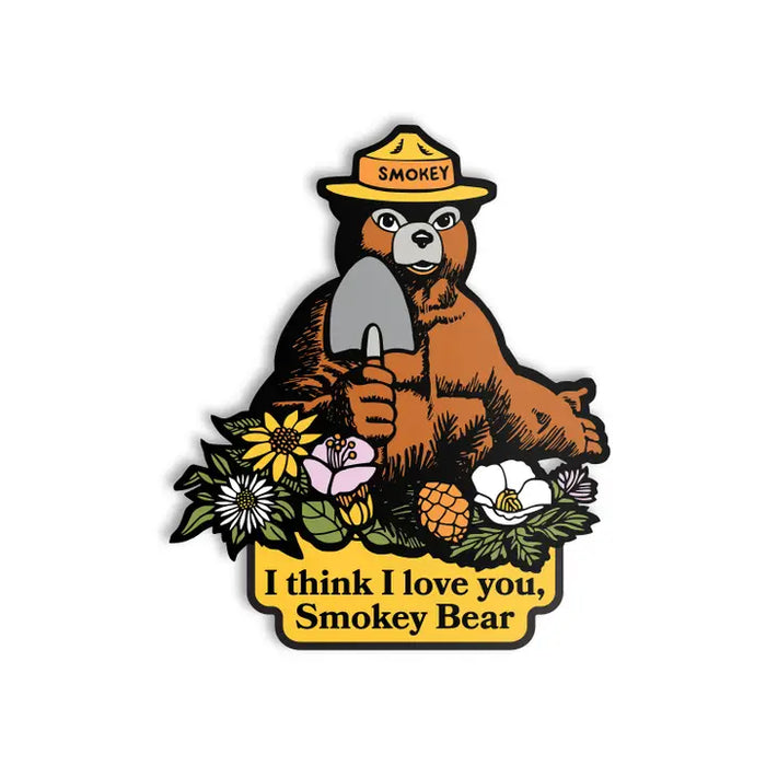 Sticker of Smokey Bear holding a shovel with floral elements and text on a white background