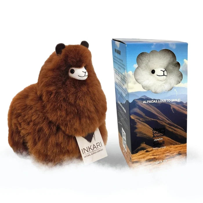 A brown plush alpaca toy next to its retail box on a white background. The box features a picture of an alpaca in the clouds and the text 'ALPACAS LOVE TO SMILE'.