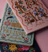 Two Jane Austen books, 'Pride and Prejudice' and 'Emma', on a colorful background.