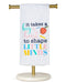 Towel with educational quote and apple graphic on a stand against a white background