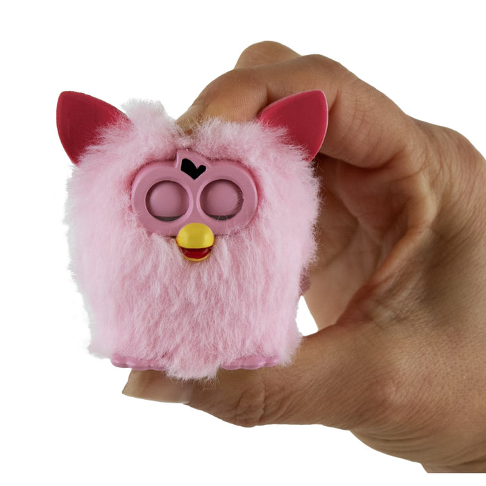 Pink fuzzy airpods case with red ears held in a hand against a white background