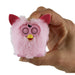 Pink fuzzy airpods case with red ears held in a hand against a white background