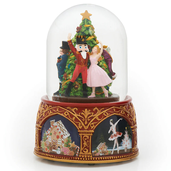 Decorative snow globe with Nutcracker scene and gingerbread house design on base
