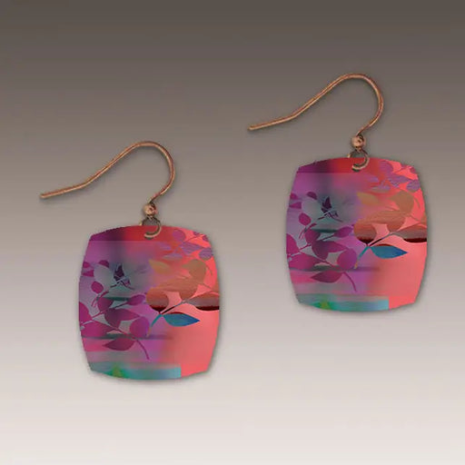 Colorful earrings with floral design on a gray background