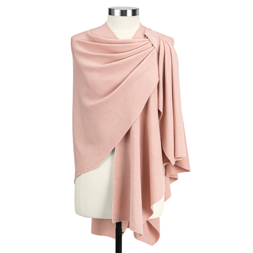 Pink draped fabric on a mannequin against a white background