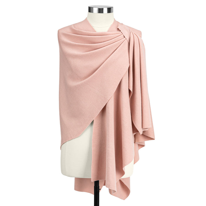 Pink draped fabric on a mannequin against a white background