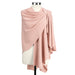 Pink draped fabric on a mannequin against a white background