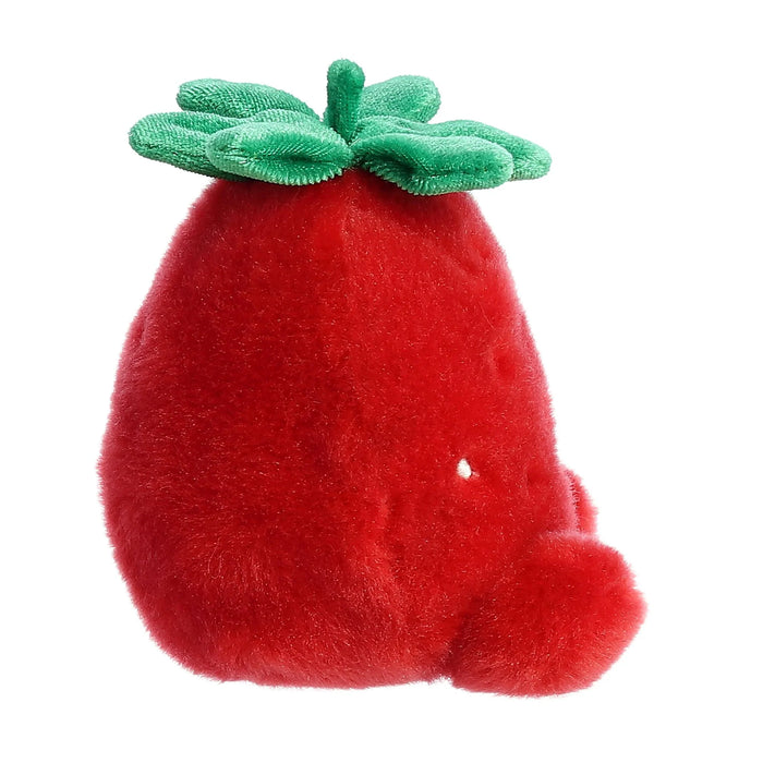 Red plush strawberry toy with green leaves on a white background