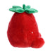 Red plush strawberry toy with green leaves on a white background