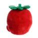 Red plush apple with green leaves on a white background