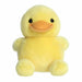 Yellow plush duck toy on a white background