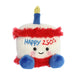 Plush toy resembling a cake with a candle, wearing a red outfit and blue gloves, on a white background.
