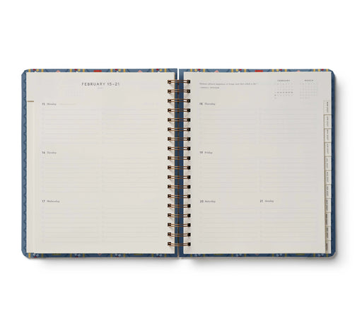 Open planner with blue and white design on a white background