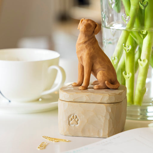 3.375”H carved figurine of large golden dog affixed to lid of 2.0”H putty-colored box
