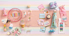 Collection of birthday-themed party supplies on a striped background
