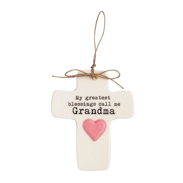 Decorative cross ornament with 'My greatest blessings call me Grandma' text and pink heart on a white background.