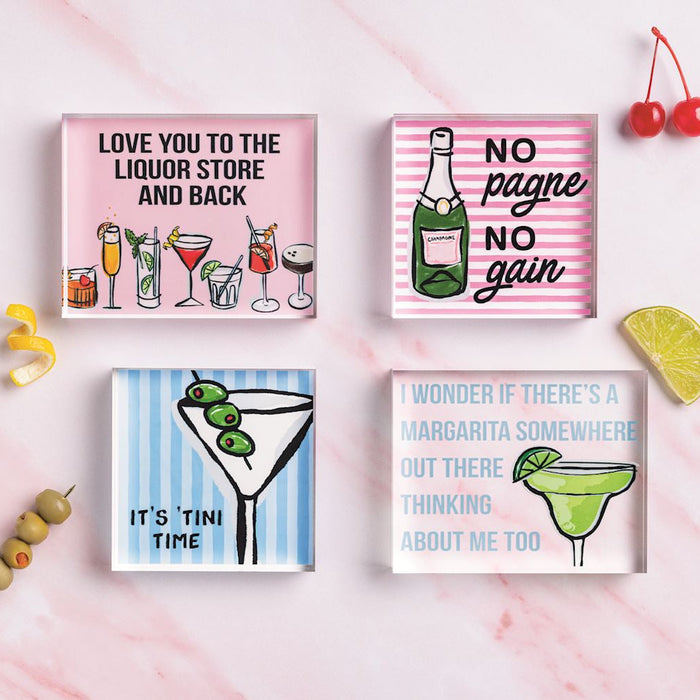 Four cocktail-themed coasters with humorous sayings on a pink background