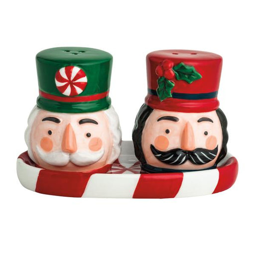 Christmas-themed salt and pepper shakers with candy cane base on a white background
