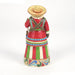 Colorful figurine with a traditional outfit and hat on a white background