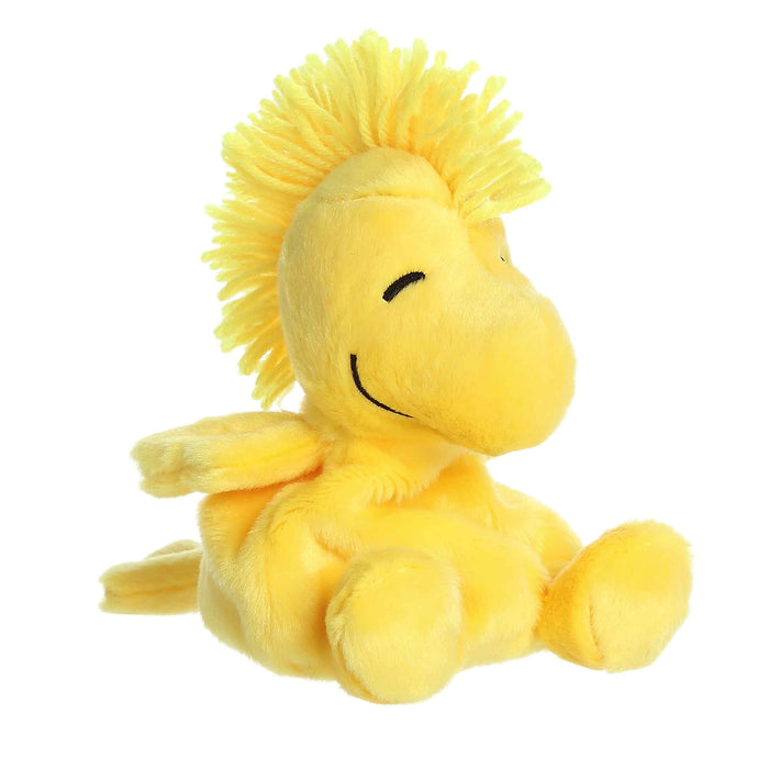 Yellow plush lion toy with a happy expression on a white background
