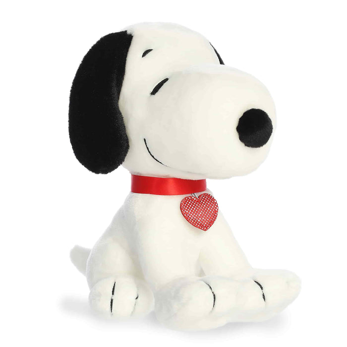 Plush dog toy with a red collar and heart-shaped tag on a white background