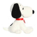 Plush toy resembling a dog with a black snout and red collar on a white background