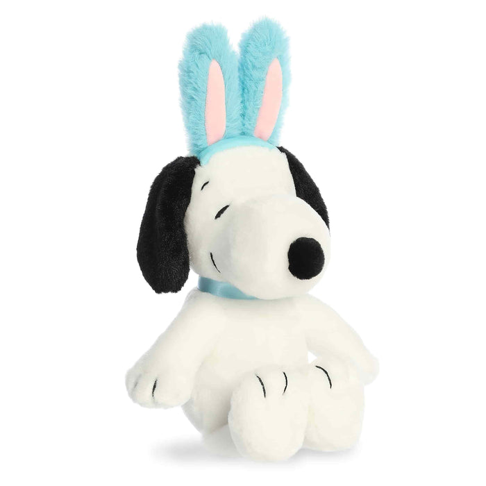 Plush toy of a dog with bunny ears on a white background