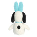 Plush toy resembling a dog with black ears and face, wearing a blue outfit on a white background
