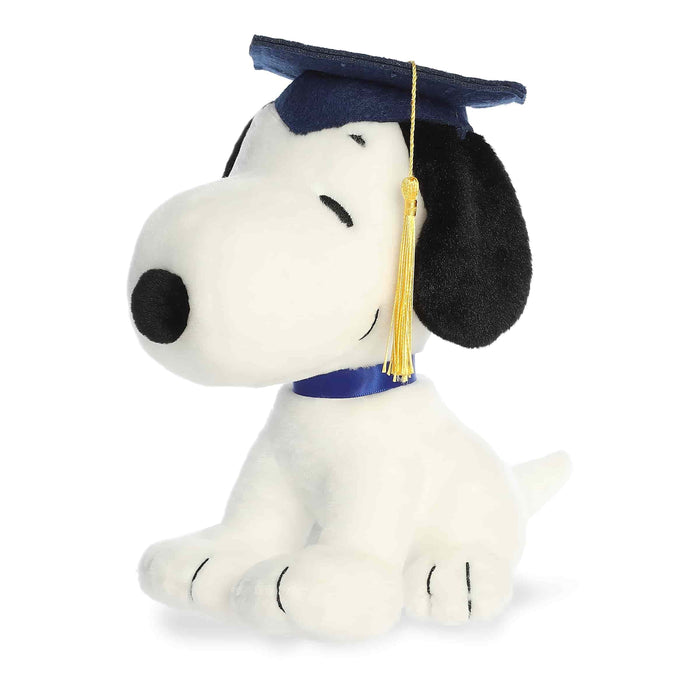 Plush toy of a dog wearing a graduation cap and tassel on a white background