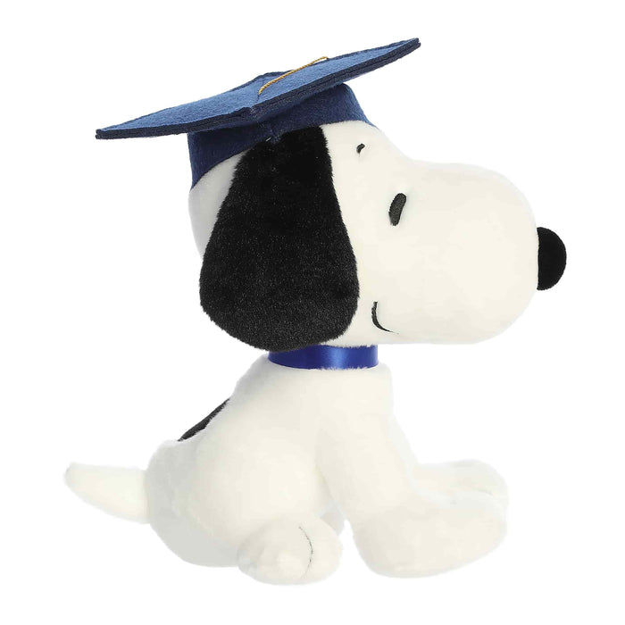 Plush toy of a dog wearing a graduation cap on a white background