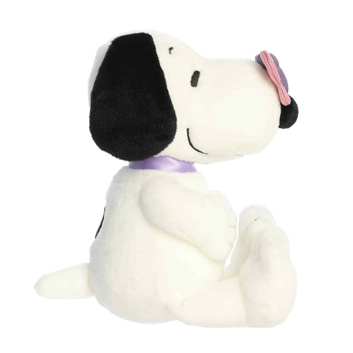 Plush toy resembling a dog with a black nose and white body on a white background