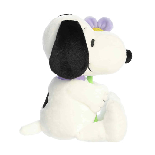 Plush toy resembling a dog with a flower on a white background