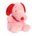 Pink plush dog toy with red ears on a white background