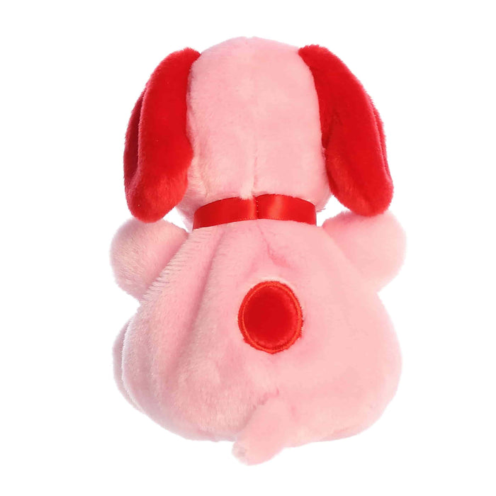 Pink plush dog toy with red accents on a white background
