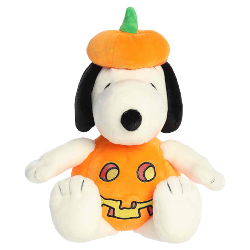 Plush toy resembling a dog in a Halloween costume with a pumpkin hat on a white background