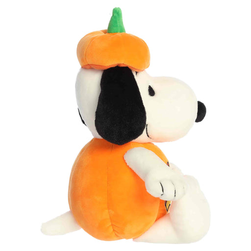 Plush toy of a dog wearing an orange pumpkin costume on a white background