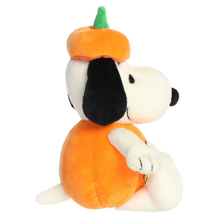 Plush toy of a dog wearing an orange pumpkin costume on a white background