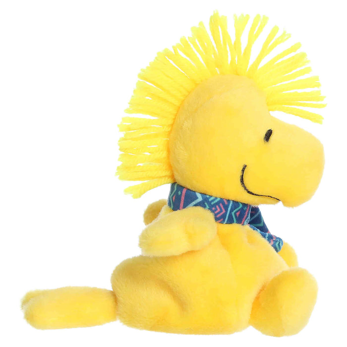 Woodstock plush toy with a blue winter pattern scarf on a white background