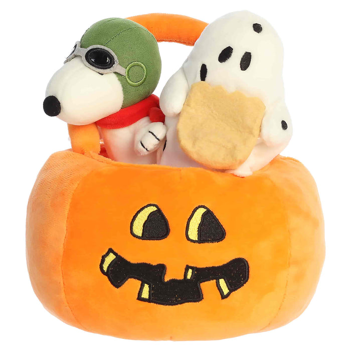 Plush toys resembling a dog and a ghost in a Halloween pumpkin basket on a white background