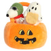 Plush toys resembling a dog and a ghost in a Halloween pumpkin basket on a white background