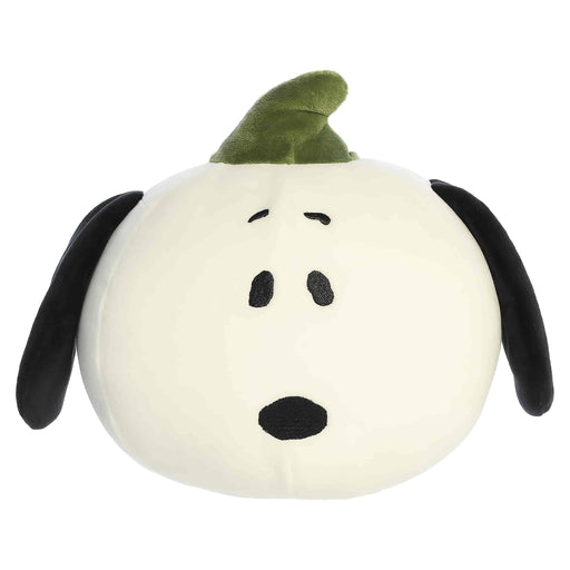 Plush toy shaped like a dog with a green hat on a white background