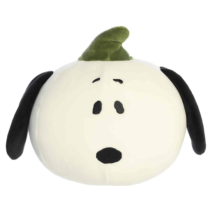 Plush toy shaped like a dog with a green hat on a white background