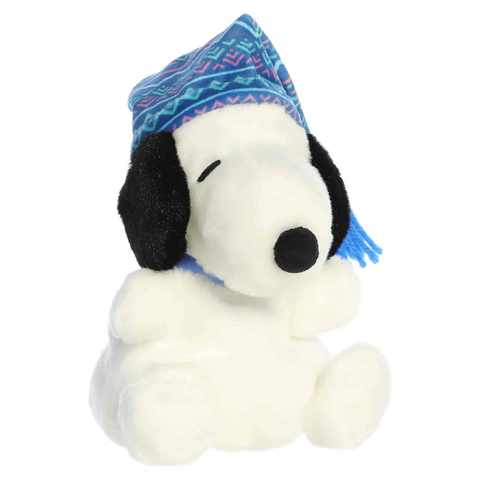 Snoopy plush toy with a blue winter-pattern hat on a white background