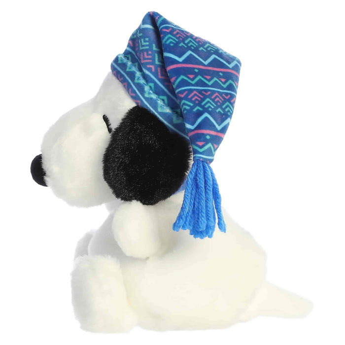 Snoopy plush toy with a blue winter-pattern hat on a white background
