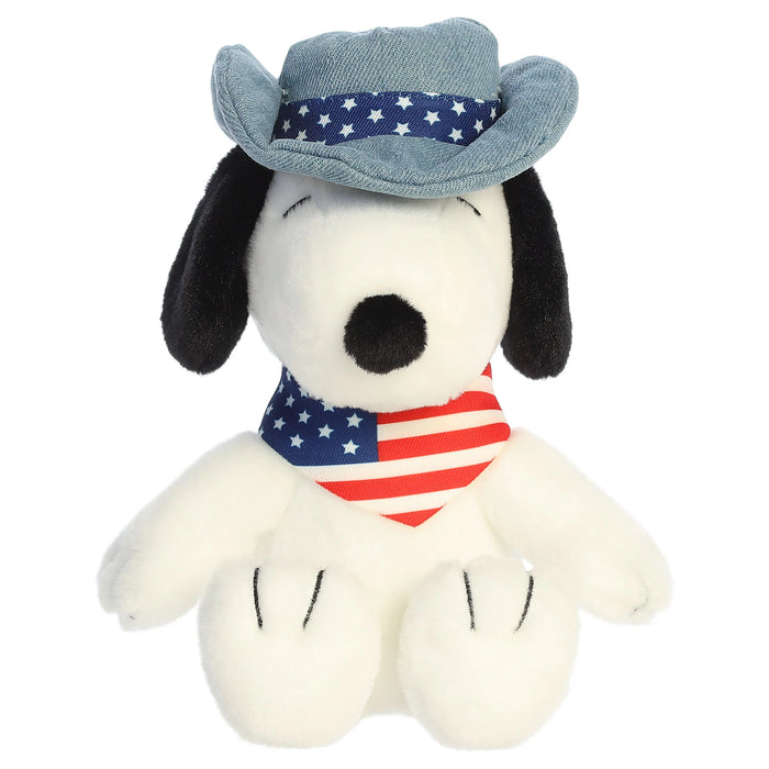 Snoopy plush toy with a cowboy hat and an American flag bandana on a white background