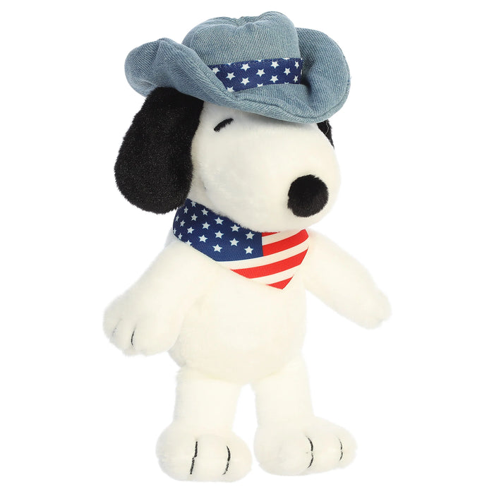 Snoopy plush toy with a cowboy hat and an American flag bandana on a white background